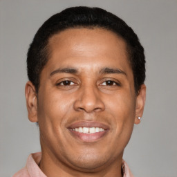 Joyful latino young-adult male with short  brown hair and brown eyes