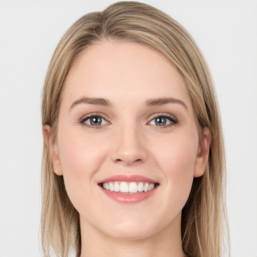 Joyful white young-adult female with long  brown hair and green eyes