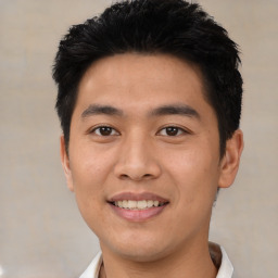 Joyful asian young-adult male with short  black hair and brown eyes