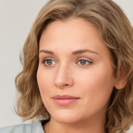 Joyful white young-adult female with medium  brown hair and green eyes