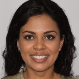 Joyful black young-adult female with medium  brown hair and brown eyes