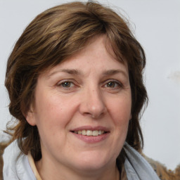 Joyful white adult female with medium  brown hair and grey eyes