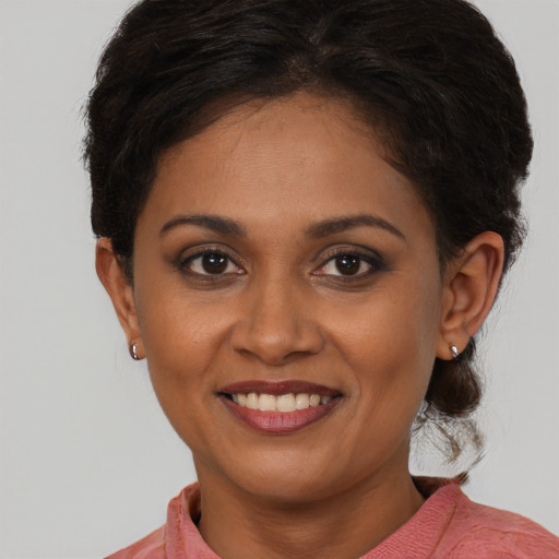 Joyful black young-adult female with short  brown hair and brown eyes