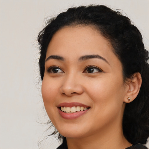 Joyful latino young-adult female with medium  black hair and brown eyes