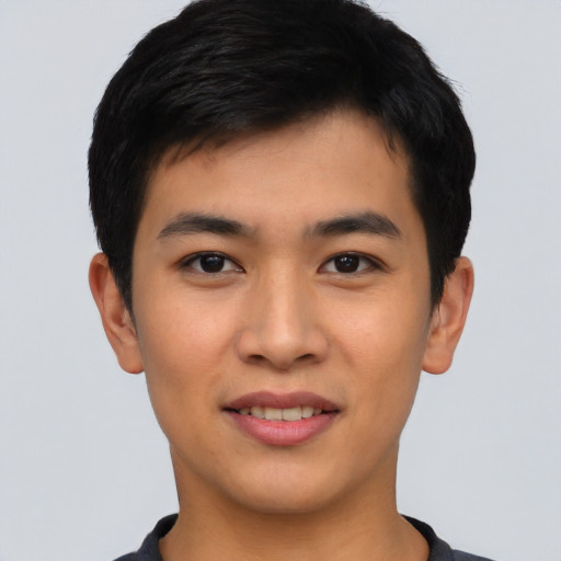 Joyful asian young-adult male with short  black hair and brown eyes