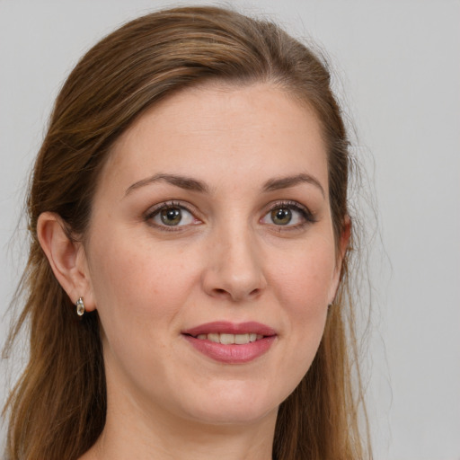 Joyful white young-adult female with long  brown hair and grey eyes