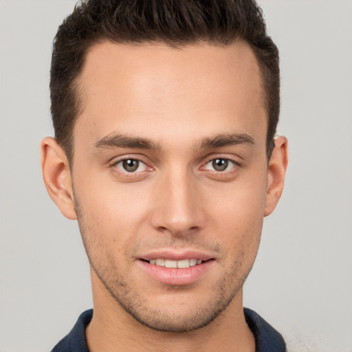 Joyful white young-adult male with short  brown hair and brown eyes