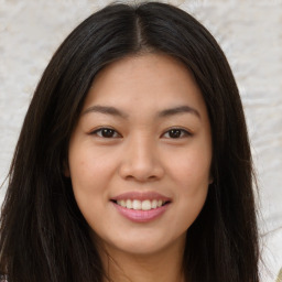 Joyful asian young-adult female with long  brown hair and brown eyes