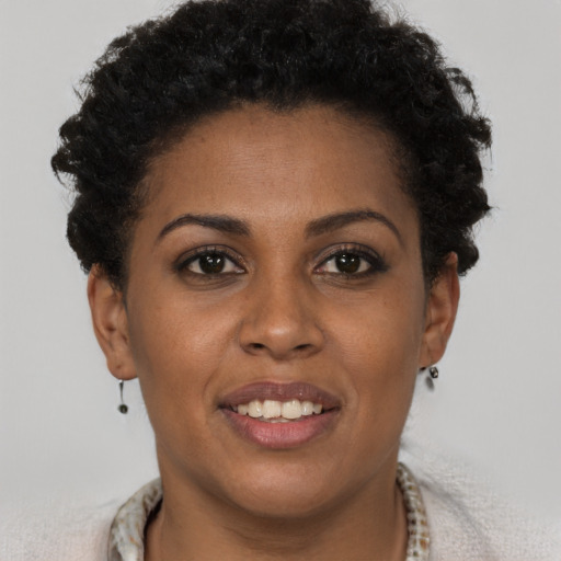 Joyful black young-adult female with short  brown hair and brown eyes
