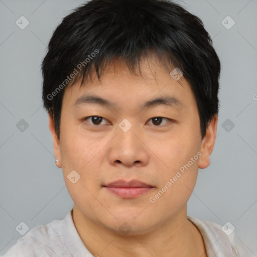 Joyful asian young-adult male with short  brown hair and brown eyes