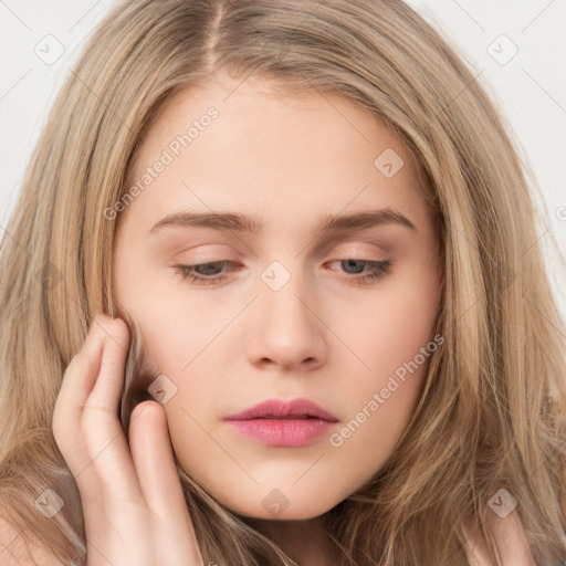 Neutral white young-adult female with long  brown hair and brown eyes