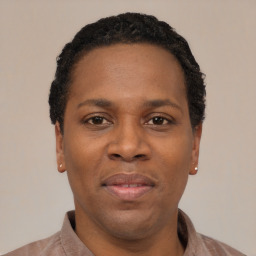 Joyful black young-adult female with short  black hair and brown eyes
