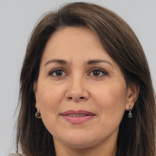 Joyful white adult female with long  brown hair and brown eyes