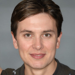 Joyful white adult male with short  brown hair and grey eyes