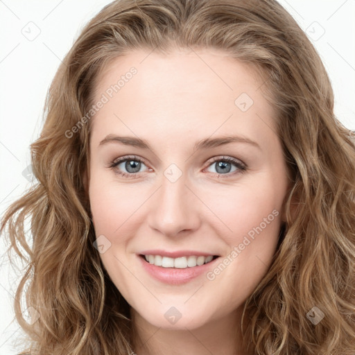 Joyful white young-adult female with long  brown hair and blue eyes