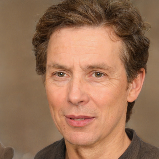 Joyful white adult male with short  brown hair and grey eyes