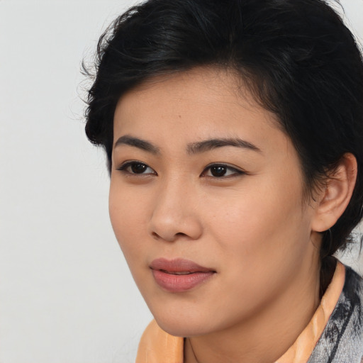 Joyful asian young-adult female with short  black hair and brown eyes