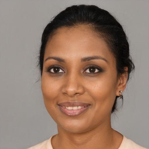 Joyful black young-adult female with medium  black hair and brown eyes