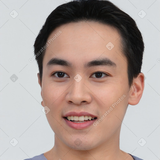 Joyful asian young-adult male with short  black hair and brown eyes