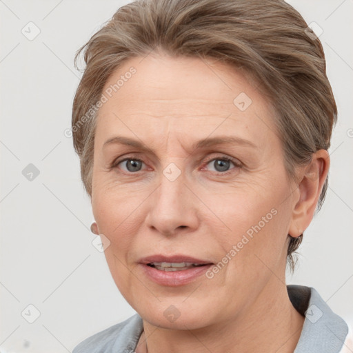 Joyful white adult female with medium  brown hair and grey eyes