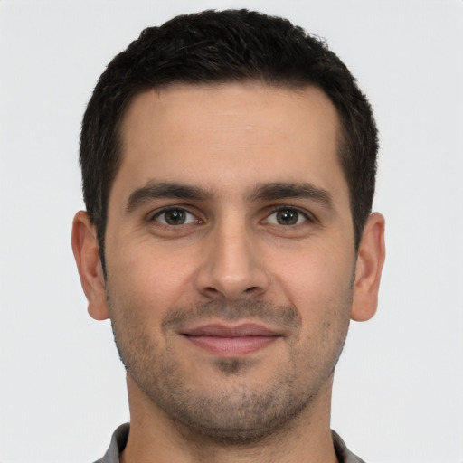 Joyful white young-adult male with short  brown hair and brown eyes