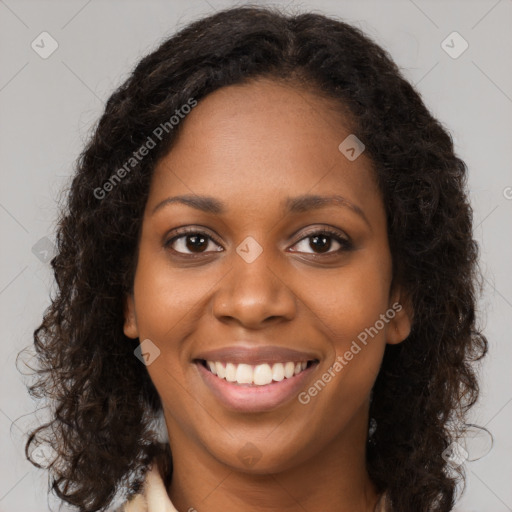 Joyful black young-adult female with long  brown hair and brown eyes