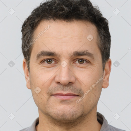 Joyful white adult male with short  brown hair and brown eyes