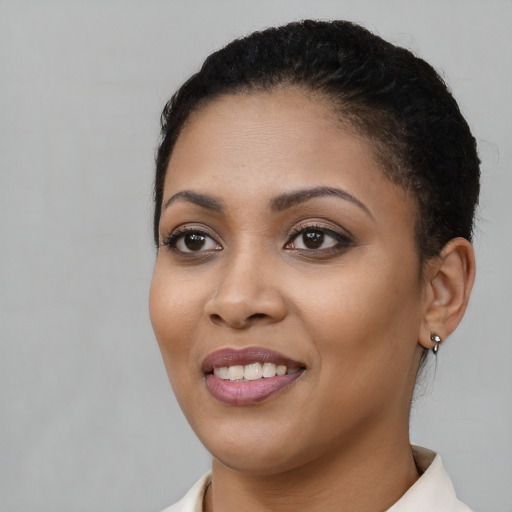 Joyful latino young-adult female with short  black hair and brown eyes