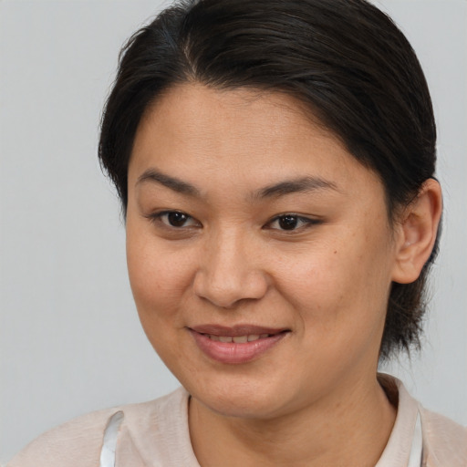 Joyful asian young-adult female with medium  brown hair and brown eyes