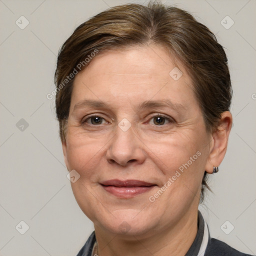 Joyful white adult female with medium  brown hair and grey eyes