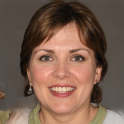 Joyful white adult female with medium  brown hair and brown eyes