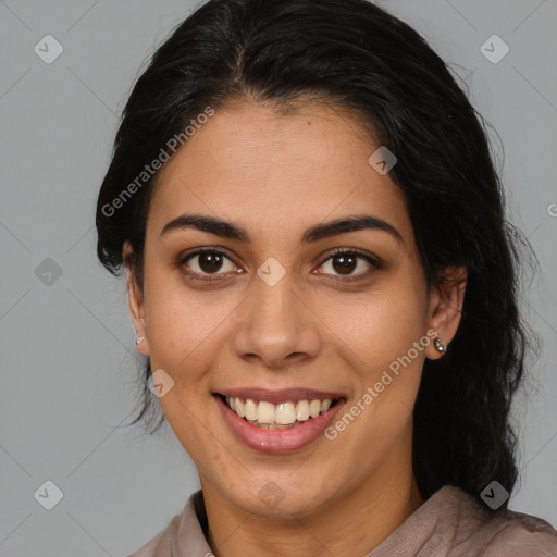 Joyful latino young-adult female with medium  brown hair and brown eyes