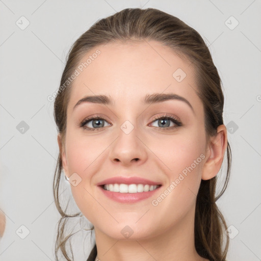 Joyful white young-adult female with long  brown hair and grey eyes