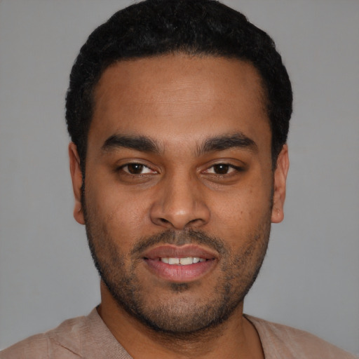 Joyful latino young-adult male with short  black hair and brown eyes