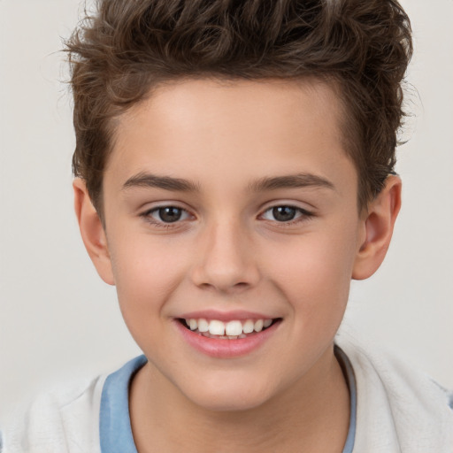 Joyful white child male with short  brown hair and brown eyes