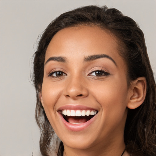 Joyful white young-adult female with long  brown hair and brown eyes