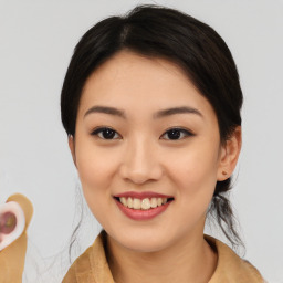 Joyful asian young-adult female with medium  brown hair and brown eyes