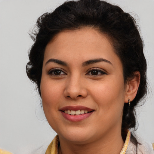 Joyful latino young-adult female with medium  brown hair and brown eyes