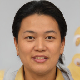Joyful asian adult female with short  brown hair and brown eyes