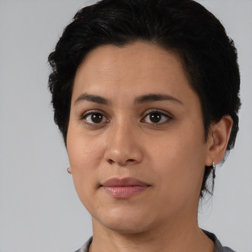 Joyful latino young-adult female with medium  black hair and brown eyes