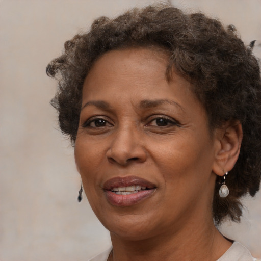 Joyful black adult female with medium  brown hair and brown eyes