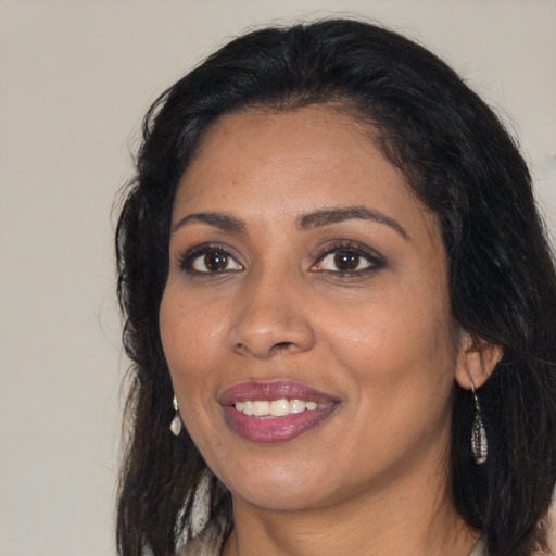 Joyful black adult female with medium  black hair and brown eyes