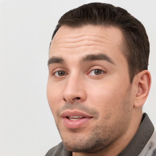 Joyful white young-adult male with short  black hair and brown eyes