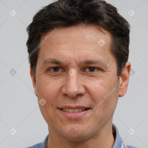 Joyful white adult male with short  brown hair and brown eyes