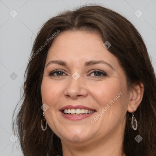 Joyful white adult female with long  brown hair and brown eyes