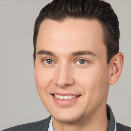 Joyful white young-adult male with short  brown hair and brown eyes