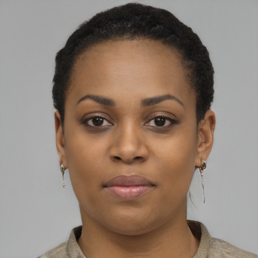 Joyful black young-adult female with short  black hair and brown eyes