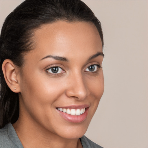 Joyful latino young-adult female with long  brown hair and brown eyes