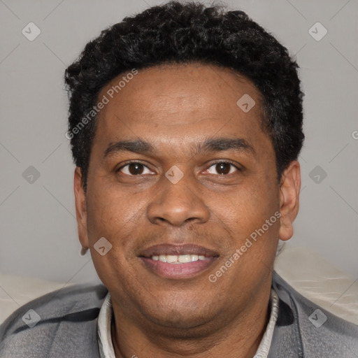 Joyful black young-adult male with short  black hair and brown eyes