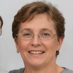 Joyful white adult female with short  brown hair and grey eyes